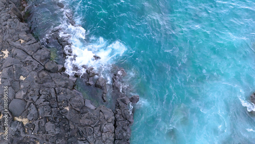 A drone shot of the beautiful sea scenery of Jeju Island, Korea, which boasts a green emerald cleanliness. Best healing trip. Harmony of basalt and waves