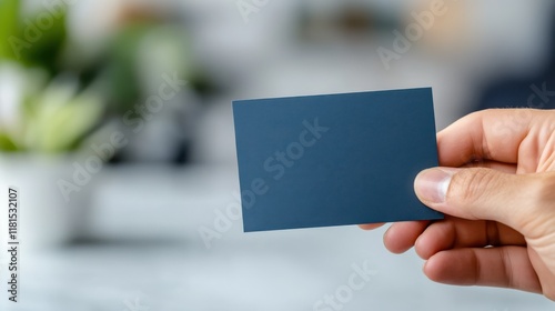 Holding a green card in a minimalist setting with a pure white background photo