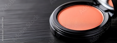 Close-up of vibrant blush compact on table. photo