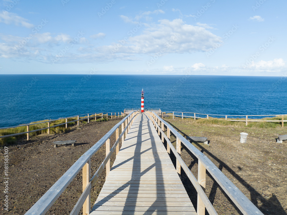 Small lighthouse on rugged cliff line of the Azores, Sao Miguel, shipping beacon, vulcanic rocks, aerial drone video Small lighthouse on rugged cliff line of the Azores, Sao Miguel, shipping beacon, vulcanic rocks, aerial drone video