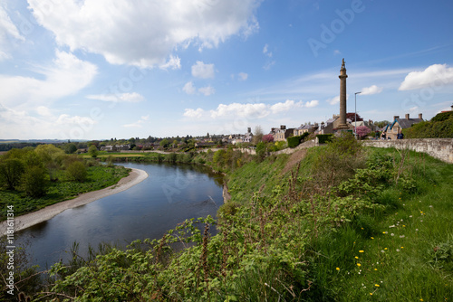 Scenic view of the River Esk and the historic monument in Scotland on a sunny afternoon photo