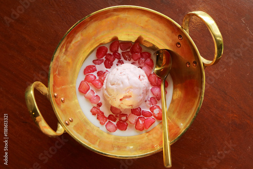 Popular Thai dessert called Tub Tim Grob or Mock Pomegranate in coconut milk served with ice cream photo