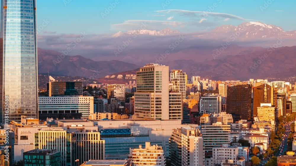 Aerial panoramic of Santiago de Chile, El Plomo Hill, Andean Cordillera background over sunset downtown