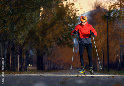 Athlete on the roller skaters in the autumn park photo