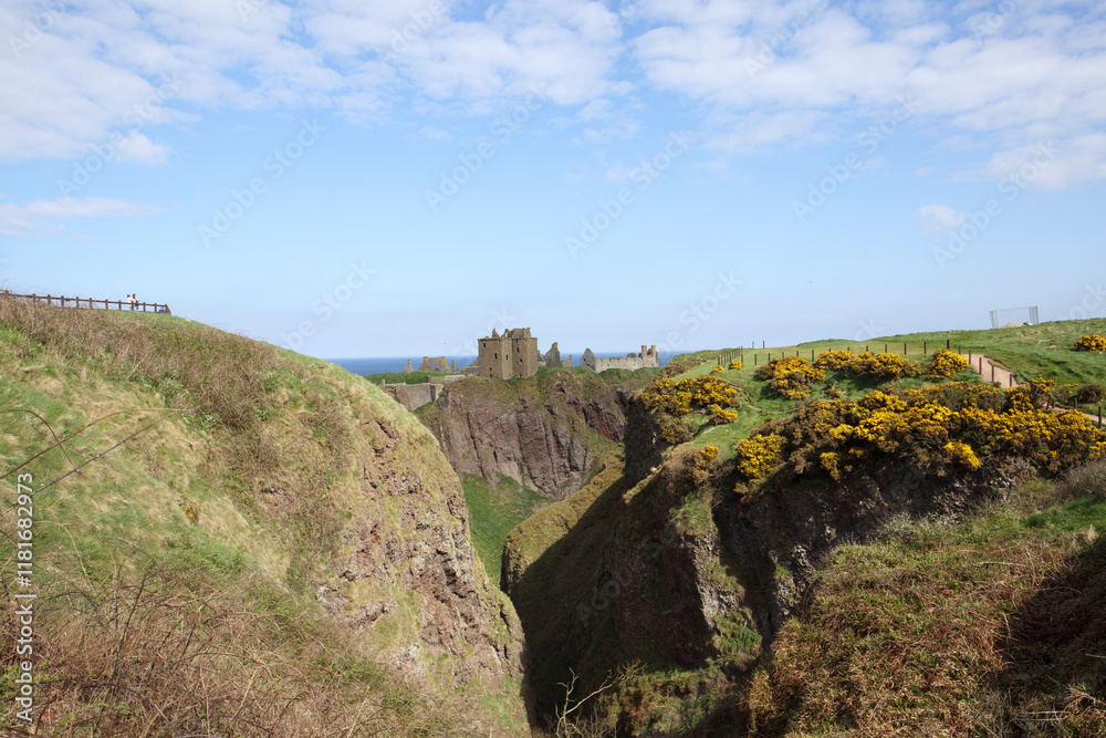 Majestic Dunnottar Castle overlooking the rugged cliffs and scenic coastline of Stonehaven, Scotland on a sunny day Majestic Dunnottar Castle overlooking the rugged cliffs and scenic coastline of Stonehaven, Scotland on a sunny day