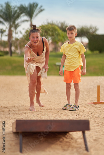 Mother with son plays bean bag game cornhole in Egypt Hurghada