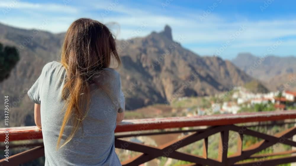 woman admires the wonderful Roque Bentayga from the village of Tejeda. Gran Canarias, Spain. woman admires the wonderful Roque Bentayga from the village of Tejeda. Gran Canarias, Spain.