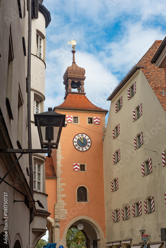 .Regensburg Clock Tower at the entrance of the Stone Bridge, iconic landmarks of medieval Bavarian German city of Regensburg on the River Danube, Germany. photo