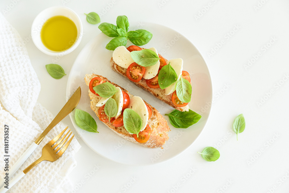 Bruschetta toasts with mozzarella, cherry tomato and basil leaves on white wooden table Bruschetta toasts with mozzarella, cherry tomato and basil leaves on white wooden table