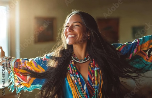 a happy young Native American woman in a colorful traditional dress with long hair, dancing and laughing in a bright room photo