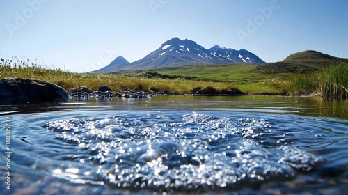 A serene lake mirrors the towering peaks of a mountain, capturing its grandeur and casting an ethereal glow upon the landscape. Arnarstapi, a coastal gem on Sn?fellsnes Peninsula in West Iceland photo