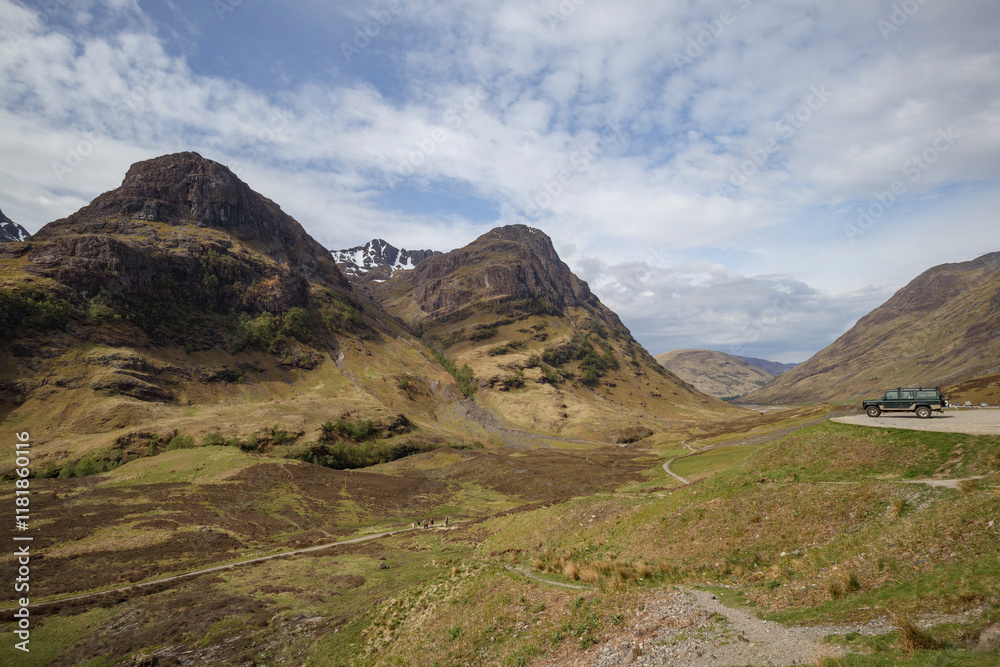Breathtaking view of Glencoe Valley in Scotland with rugged mountains and a winding road Breathtaking view of Glencoe Valley in Scotland with rugged mountains and a winding road
