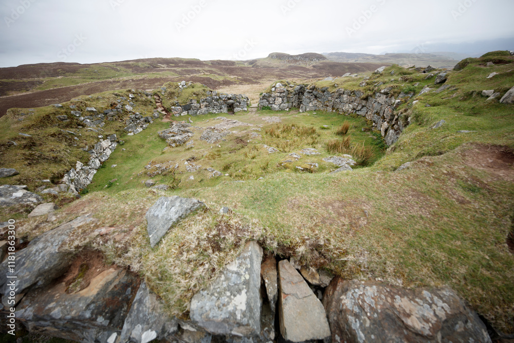 Ancient stone ruins on a grassy hillside in Isle of Skye, Scotland, exploring historical sites amidst serene landscapes Ancient stone ruins on a grassy hillside in Isle of Skye, Scotland, exploring historical sites amidst serene landscapes