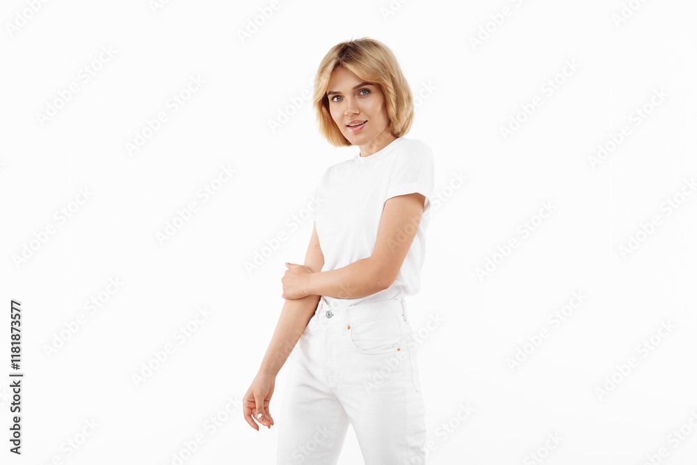 Attractive young blonde woman in casual white outfit posing over white background. Attractive young blonde woman in casual white outfit posing over white background.