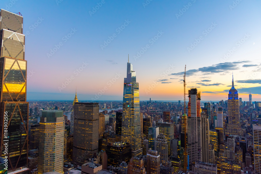 Manhattan skyline under a colorful sky at sunset