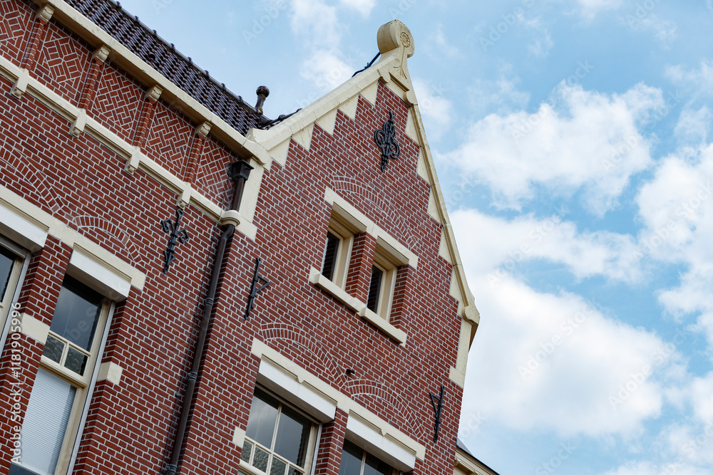 Red brick architecture featuring intricate designs against a clear blue sky near a historic district Red brick architecture featuring intricate designs against a clear blue sky near a historic district