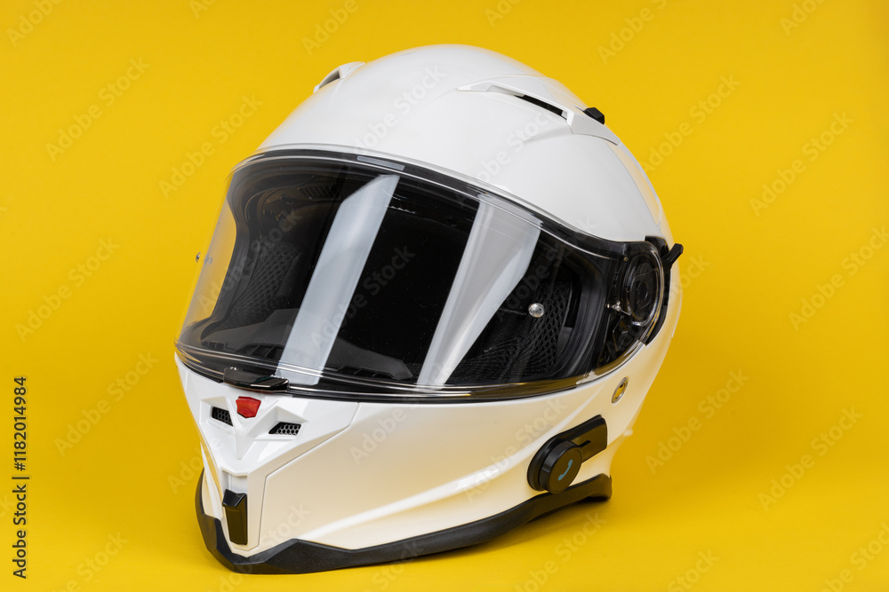 White motorcycle carbon integral crash helmet on yellow white. High quality motorcycle helmet White motorcycle carbon integral crash helmet on yellow white. High quality motorcycle helmet