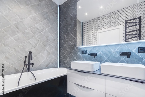 Exclusive interior design of the bathroom decorated with gray tiles. Stylish black faucets.