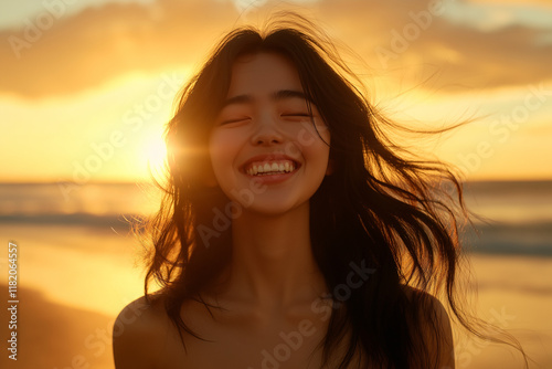 A woman stands on the beach at sunset, her hair blowing in the wind, her eyes closed in pure joy and a wide smile on her face. Generative AI