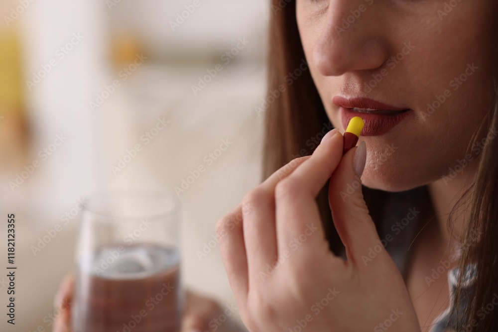 Woman taking medical pill at home, closeup Woman taking medical pill at home, closeup