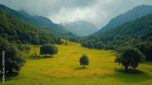 Majestic lush green valley with trees and colorful grass against high mountains in asturias in spain. beautiful view landscape with tree sky