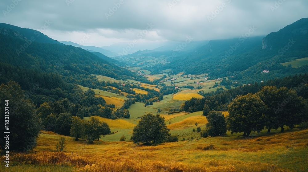Fototapeta premium Majestic lush green valley with trees and colorful grass against high mountains in asturias in spain. beautiful view landscape with tree sky
