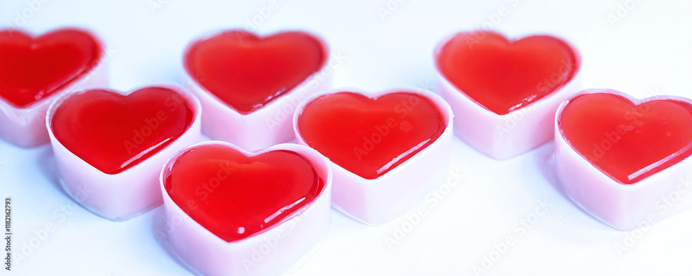 Red heart-shaped gelatin desserts arranged neatly on a white surface ready for serving at a celebration. Valentine’s Day idea, date, engagement party, love party, eat, food Red heart-shaped gelatin desserts arranged neatly on a white surface ready for serving at a celebration. Valentine’s Day idea, date, engagement party, love party, eat, food