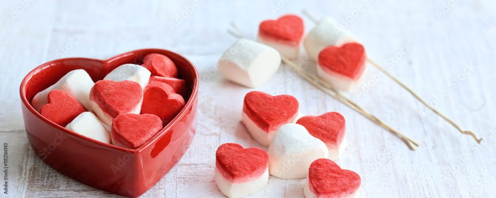 Delicious heart-shaped marshmallows arranged in a bowl on a wooden surface for a festive celebration. Valentine’s Day idea, date, engagement party, love party, eat, food