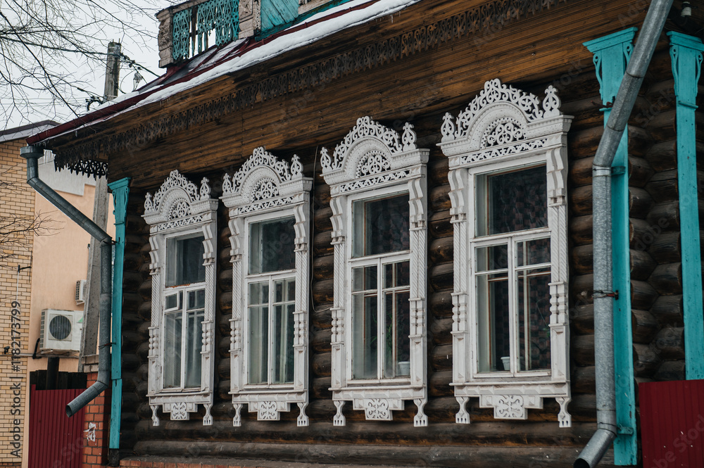Fototapeta premium carved window frames in log houses in a Russian village