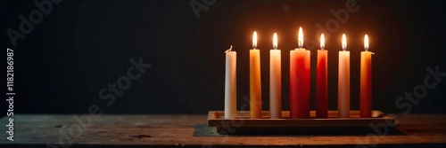 Softly glowing candles on a wooden table form a stunning menorah against the dark background, light, peaceful, dark photo