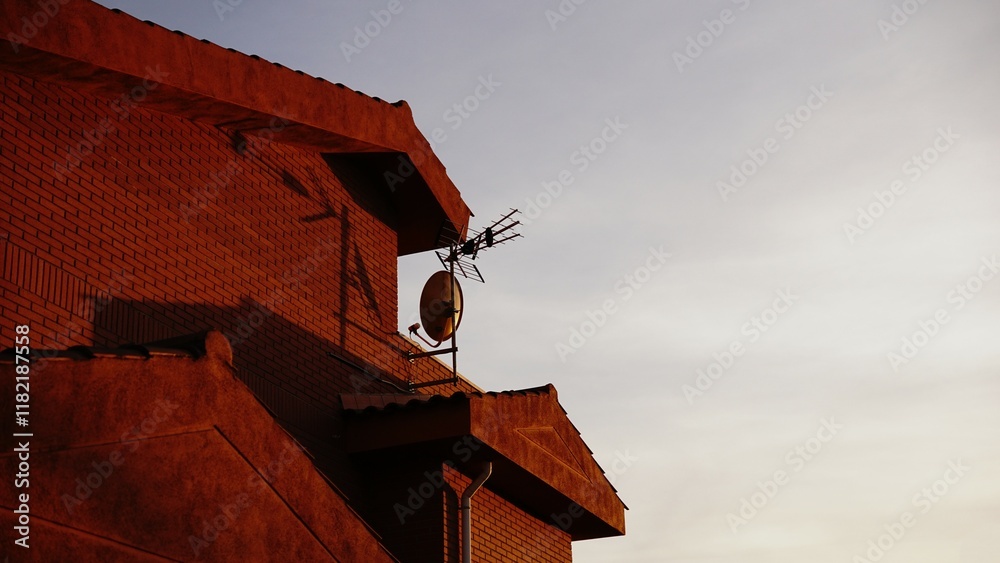 domestic house facade with tile roof in the evening domestic house facade with tile roof in the evening