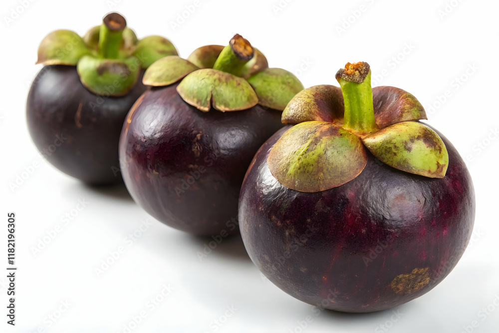 Fototapeta premium Fresh Mangosteens with Green Crown on White Surface