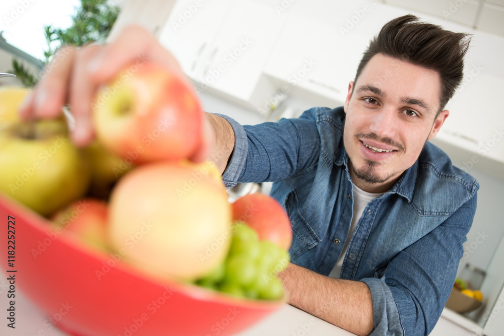 close up of man holding freshly picked apples