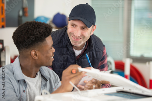 apprentice and manager laughing about subject photo