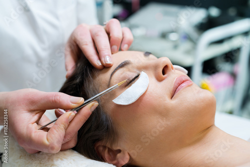 woman having eye lashes tinted in beauty salon