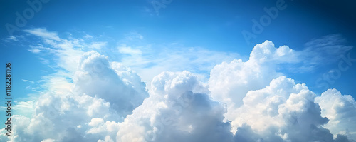 White clouds in a sunny blue sky, peaceful spring ambiance background, heavenly cloudscape