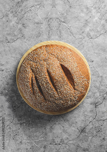 freshly baked round bread with sesame seeds photo