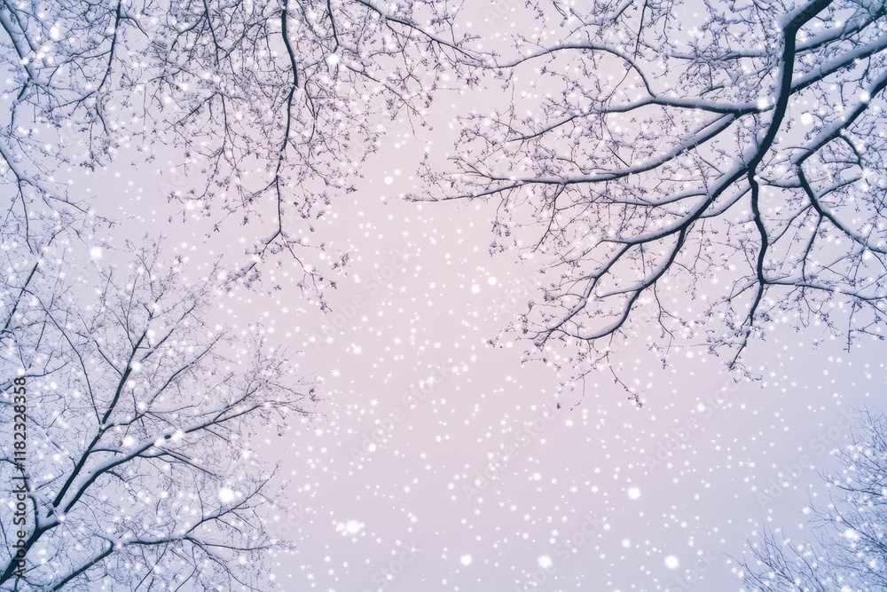 Snow-covered branches, falling snowflakes, pale sky.