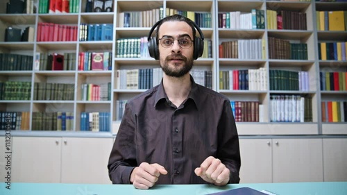 Webcam view young talking man making video call chat conference, in library