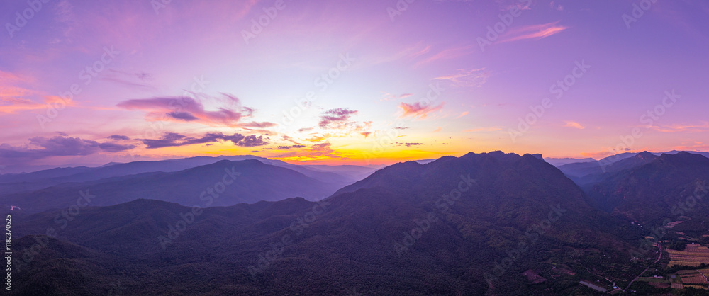 A breathtaking view of a colorful sunset over layered mountain silhouettes, with warm hues of orange, pink, and blue blending seamlessly across the sky. A breathtaking view of a colorful sunset over layered mountain silhouettes, with warm hues of orange, pink, and blue blending seamlessly across the sky.