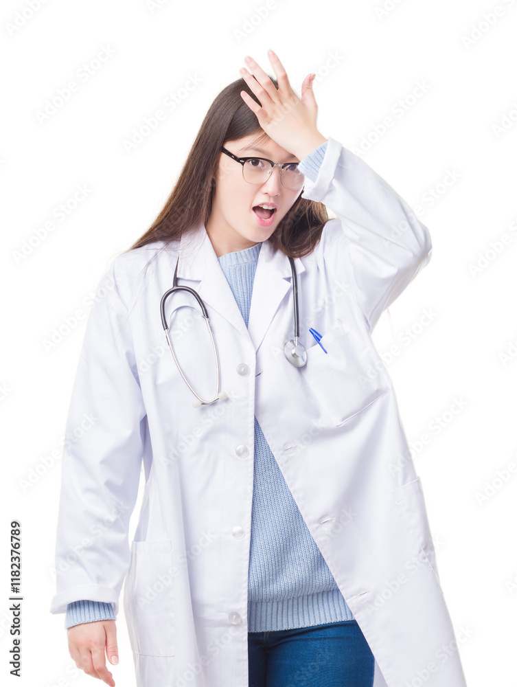 Young Chinese doctor woman over isolated background surprised with hand on head for mistake, remember error. Forgot, bad memory concept. Young Chinese doctor woman over isolated background surprised with hand on head for mistake, remember error. Forgot, bad memory concept.