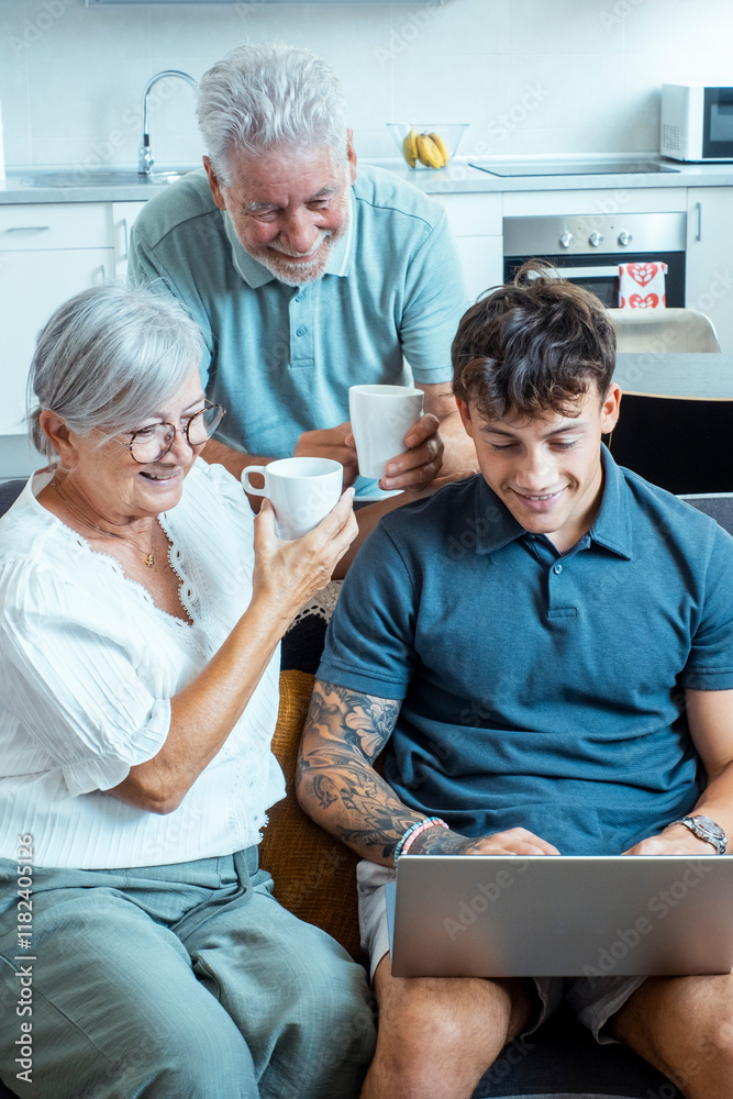 Obraz premium A family scene with grandparents and a grandson in the living room, the boy teaching them how to use the internet on a laptop while they share tea and bond over learning new skills
