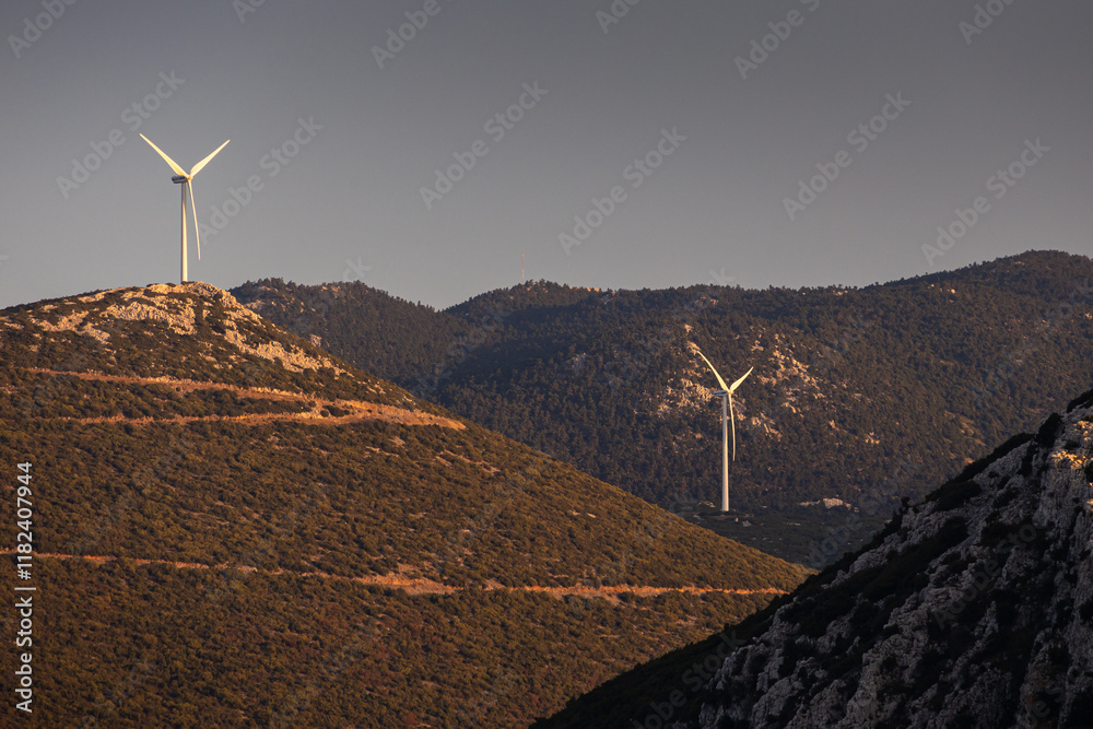 Wind turbines on the hills of Greece. Industrial concept photo for wind mills that produce electricity from wind power. Wind turbines on Parnassus mountain hills in Greece. Green energy.