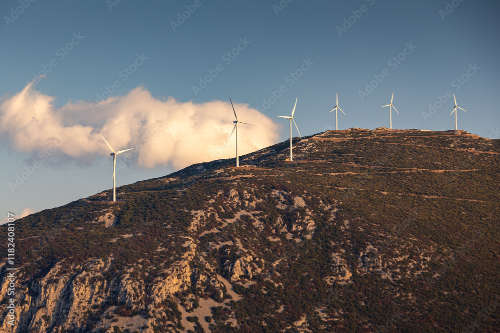 Wind turbines on the hills of Greece. Industrial concept photo for wind mills that produce electricity from wind power. Wind turbines on Parnassus mountain hills in Greece. Green energy.