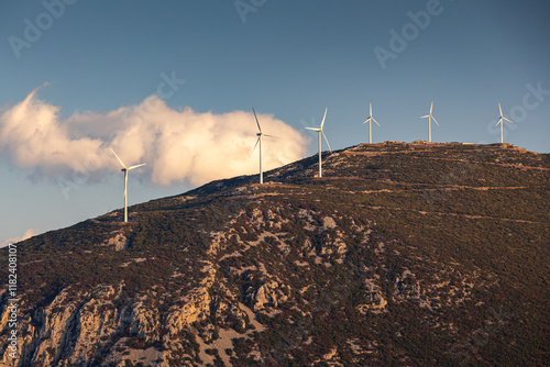 Obraz na płótnie Wind turbines on the hills of Greece. Industrial concept photo for wind mills that produce electricity from wind power. Wind turbines on Parnassus mountain hills in Greece. Green energy. w salonie