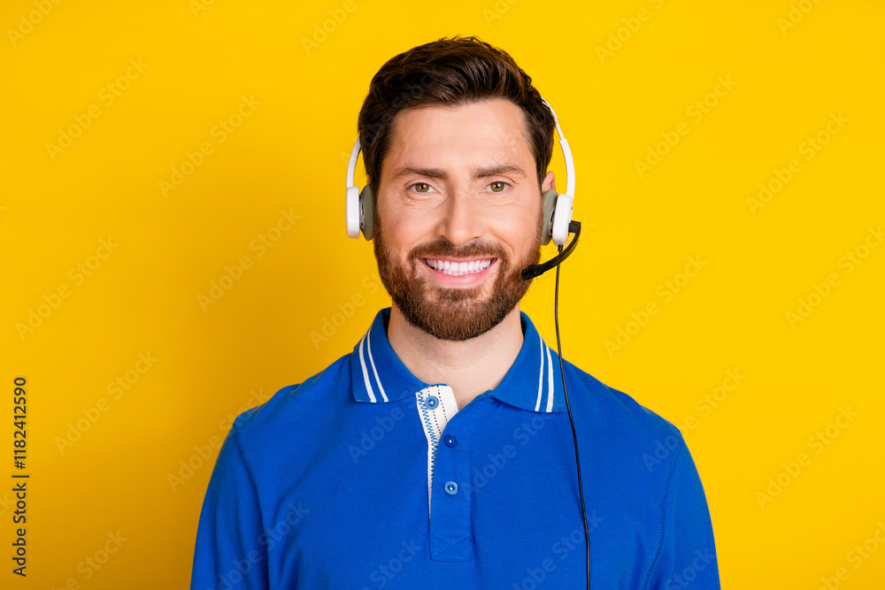 Photo portrait of attractive young man call center worker dressed stylish blue clothes isolated on yellow color background Photo portrait of attractive young man call center worker dressed stylish blue clothes isolated on yellow color background
