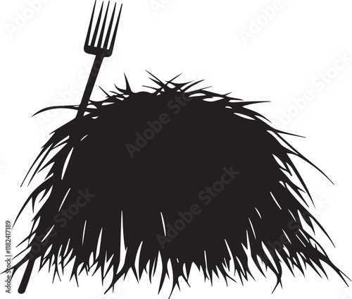 Silhouette of haystack with pitchfork beside