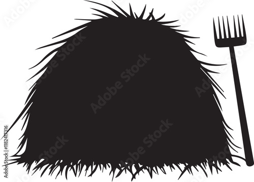 Silhouette of haystack with pitchfork beside