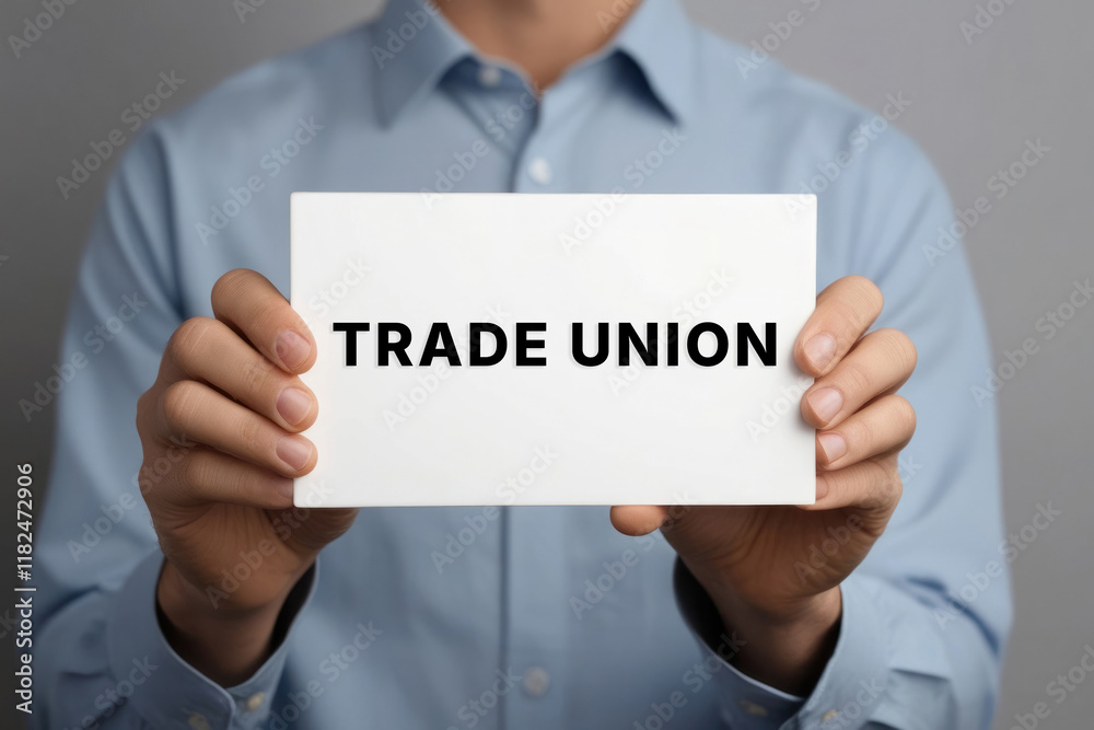 TRADE UNION text words phrase on a sign in the hands of a worker TRADE UNION text words phrase on a sign in the hands of a worker