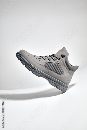 Style men's nubuck boots shoes on a gray background. Male sport shoes for walking, running or fitness. photo